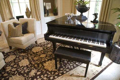 salon z fortepianem i wzorzystym dywanem